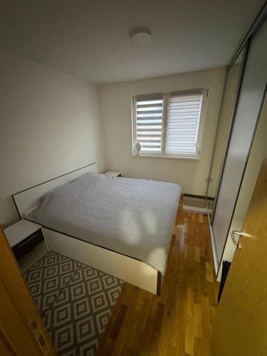 a small bedroom with a bed and a window at FocaLux in Foča