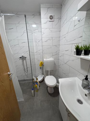 a bathroom with a toilet and a shower and a sink at FocaLux in Foča