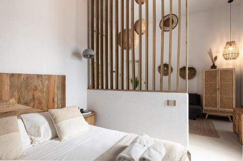 a bedroom with a bed with white sheets and wooden railings at Begani63 Boutique Apartments in Gaeta