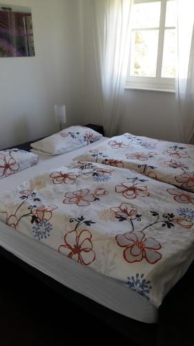 a bedroom with two beds with a floral bedspread at Ferienhaus Sonnenpier in Putbus