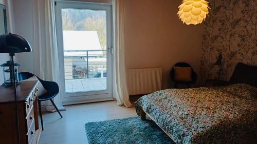 a bedroom with a bed and a sliding glass door at Ferienwohnung Am Hummerstein in Ebermannstadt