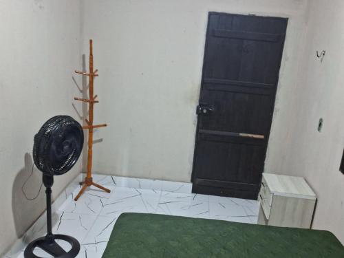 a room with a door and a fan in front of it at Casa próximo a praia in Salvaterra