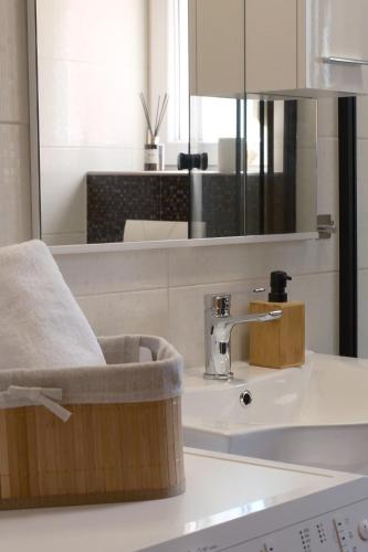 a bathroom with a sink and a mirror at Bokun Gušta in Trogir