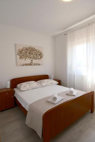 a bedroom with a bed with two towels on it at Bokun Gušta in Trogir