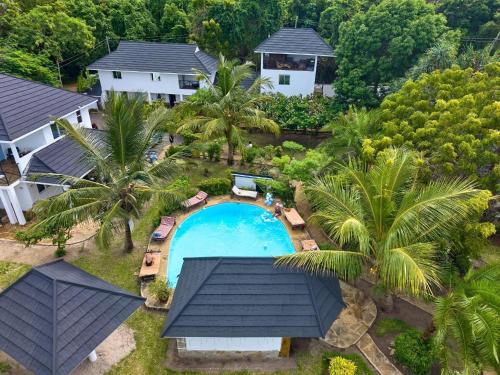 an aerial view of a house with a swimming pool at Coast Sun Gardens Cottage Adults Only in Msambweni