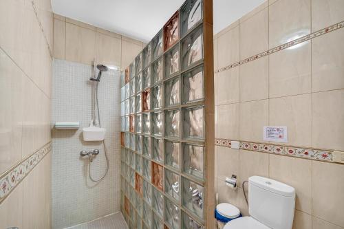 a bathroom with a shower and a toilet in it at Spacious Villa Victoria Heated Pool in Callao Salvaje