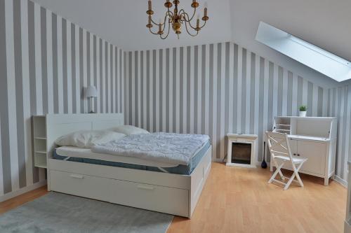 a bedroom with a bed and a desk and a chair at Herrenhaus Blengow App.15 in Blengow