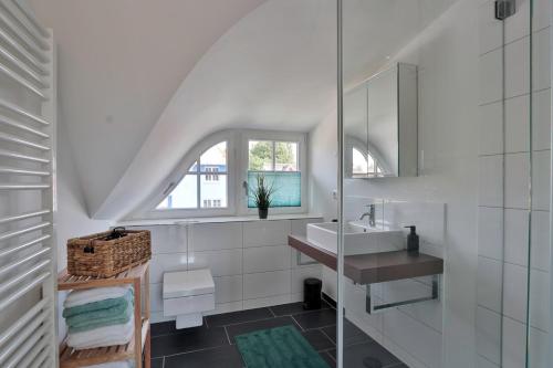 a white bathroom with a sink and a mirror at FH Wiesenkieker in Güstow