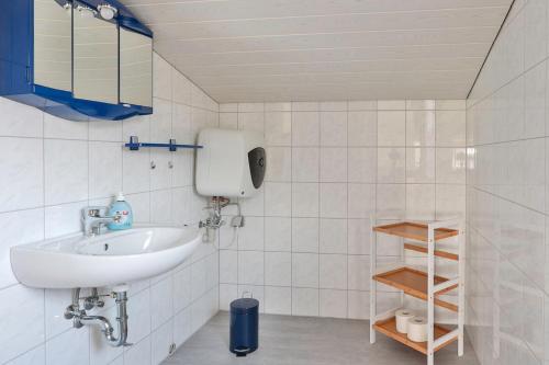 a bathroom with a sink and a soap dispenser at FeWo Geranie in Kröpelin