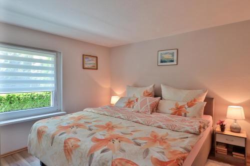 a bedroom with a large bed and a window at Bungalow Wolfgang in Kühlungsborn