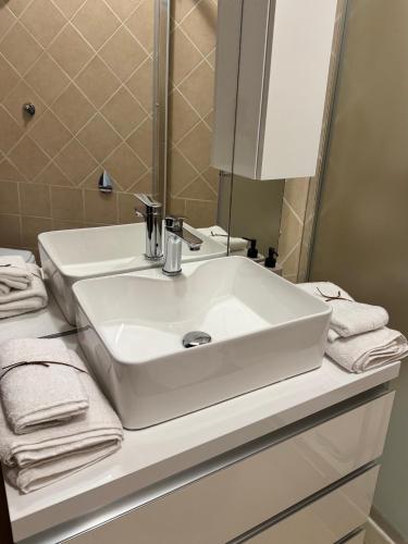 a bathroom with a white sink and a mirror at Civitavecchia Port in Civitavecchia