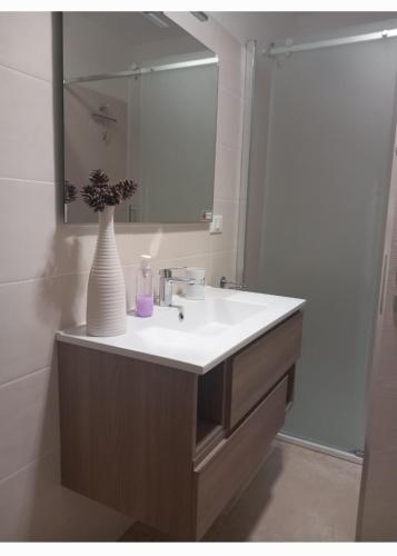 a bathroom with a sink with a vase on it at Casa Vacanze 9 Cavalieri in Maglie