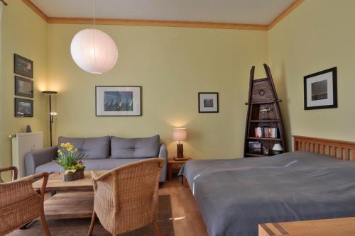a living room with a bed and a couch at Herrenhaus Blengow App.03 in Blengow