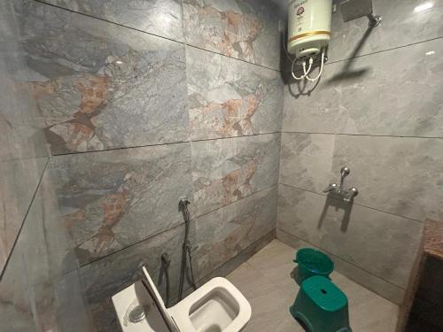 a bathroom with a toilet and a sink in it at Mahendra place in Khātu