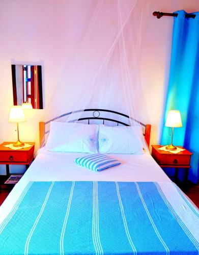 a bedroom with a large bed with two lamps at Patmos Garden Sea in Grikos