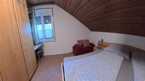 a bedroom with a bed and a wooden ceiling at Ferienwohnung Ri-Wo in Malta