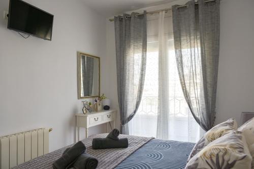 a bedroom with a bed and a large window at El Racó de la Vero in Falset