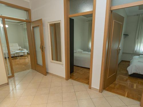 a room with doors and a bedroom with a bed at Rondo Condos by TORO in Mostar