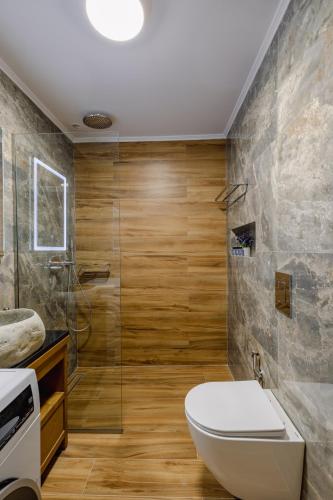 a bathroom with a toilet and a shower at Sarakina Urban Grace in Stone by 8essentially in Heraklio
