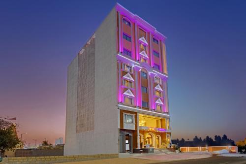 a tall building with a pink at Ira by Orchid Dwarka in Dwarka