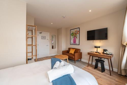 a hotel room with a bed and a desk and a television at Wee Sleep Ireland in Derry Londonderry