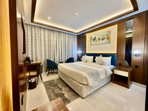 a hotel room with a bed and a desk at Smana Hotel Al Raffa in Dubai