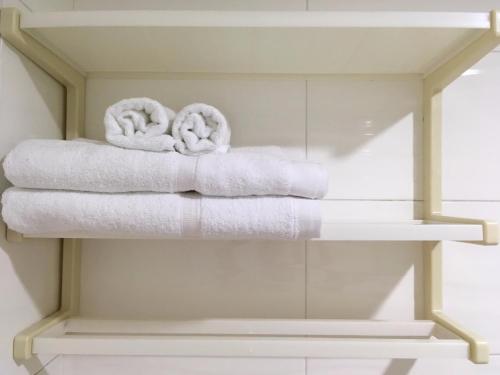 two towels on a shelf in a bathroom at HFun Hotel in Kaohsiung
