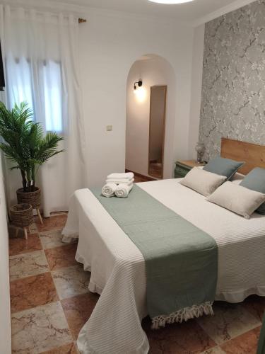 a bedroom with a large bed with towels on it at Casa Rural Hortensia in Zuheros