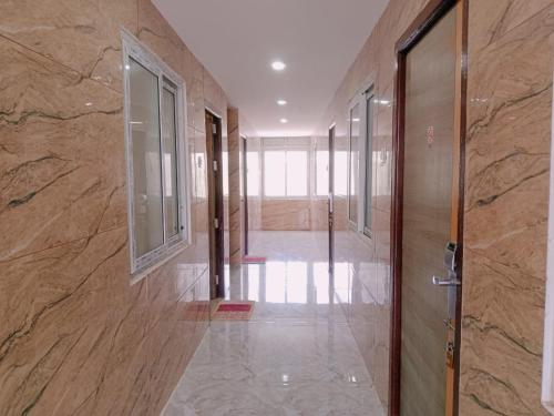 a hallway with a door in a building at GM Residency in Velankanni
