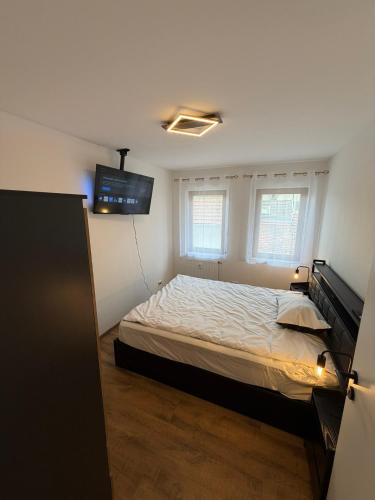 a bedroom with a bed and a flat screen tv at Main Panorama Suite 97896 Freudenberg in Freudenberg am Main