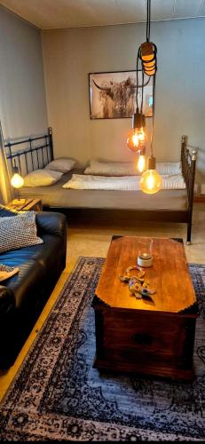 a living room with a couch and a table at Monis und Marcos B&B in Koppom