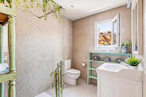 a bathroom with a white toilet and a sink at Villa Tamyan by Villa Plus in Son Parc