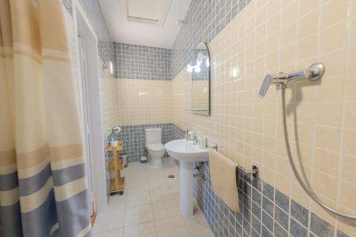 a bathroom with a sink and a toilet at Centre Algarve in Moncarapacho
