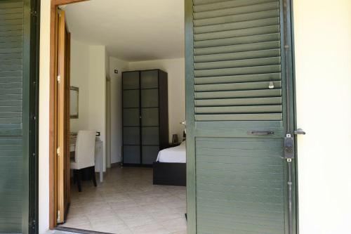 a door leading to a bedroom with a bed at Pian di luna in Sarzana