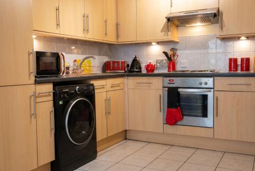 a kitchen with a washer and a dishwasher at Vintage 2-bed flat with free parking in Measham in Measham