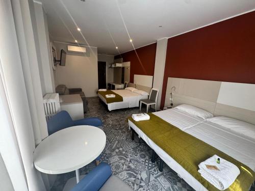 a hotel room with a bed and a table and a tablektop at Hotel Vintage Milano Centrale in Milan