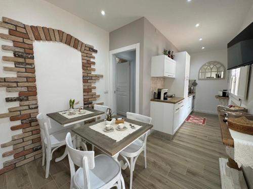 a kitchen and dining room with a table and chairs at Sabbia e Coralli in Muravera