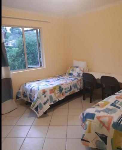 a bedroom with two beds and a window at Elikia in Pretoria
