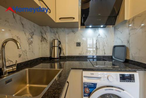 a kitchen with a washing machine in a sink at Whitestone Homes in Antalya