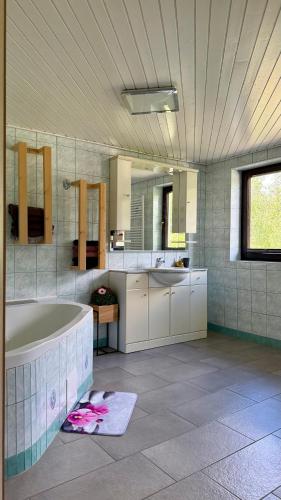 a large bathroom with a tub and a sink at Secret Paradise apartment in Zgornje Gorje
