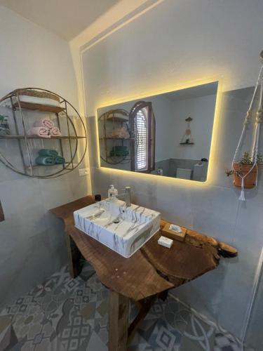 a bathroom with a sink and a mirror at Link Road 69 in Blue Bay