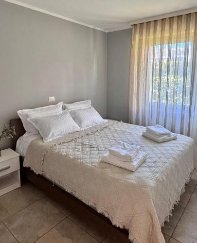 a bedroom with a bed with towels on it at Novigrad Garden Apartment in Novigrad Istria