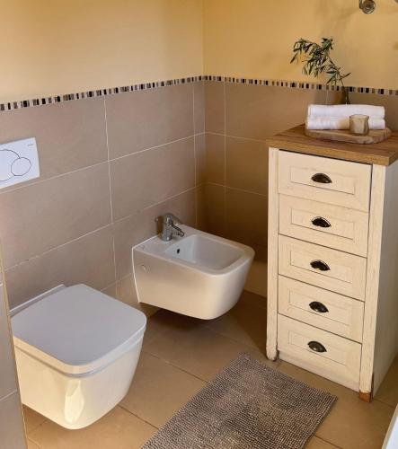 a bathroom with a toilet and a sink at Novigrad Garden Apartment in Novigrad Istria