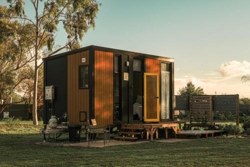 a tiny house on a picnic table in a field at D&L Cottage by Tiny Away in Kudla