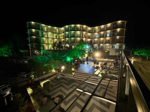 a large building at night with green lights at Barog Heights in Barog