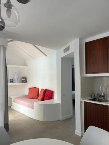 a bedroom with a bed with two red pillows at La Concha del Mar in Corralejo
