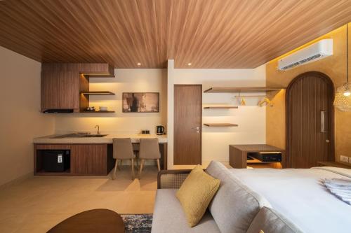 a bedroom with a bed and a kitchen with a counter at Solaris Villa Bali in Kuta