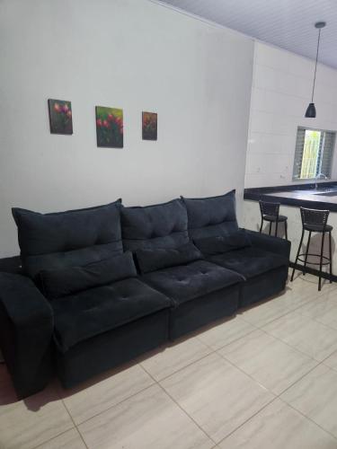 a black couch in a living room with a table at Casa Mirante da Lua in Cavalcante
