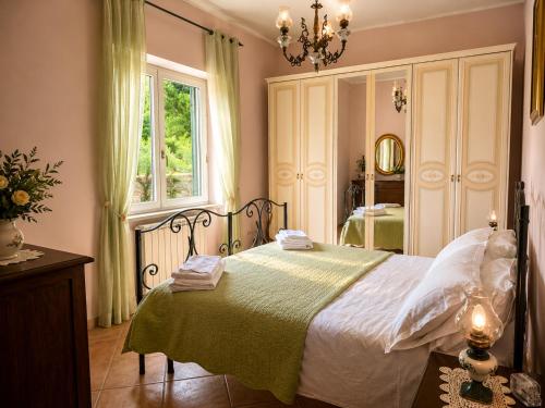 a bedroom with a bed and a window and a mirror at Holiday House Nemi in Monte Porzio
