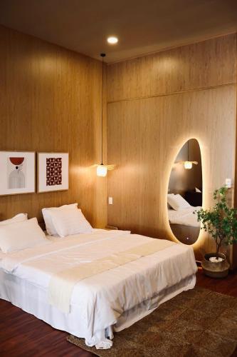 a bedroom with a large bed and a mirror at Marina Bến Du Thuyền in Ấp Long Ðại